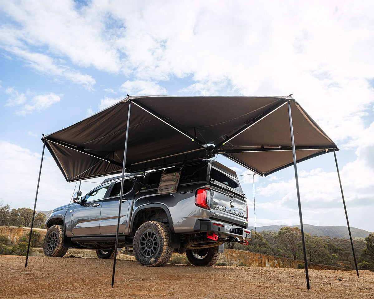 Deltawing 270 degree XL awning set up with poles over a 4x4 at camp