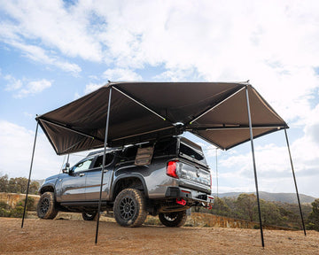 Deltawing 270 degree XL awning set up with poles over a 4x4 at camp