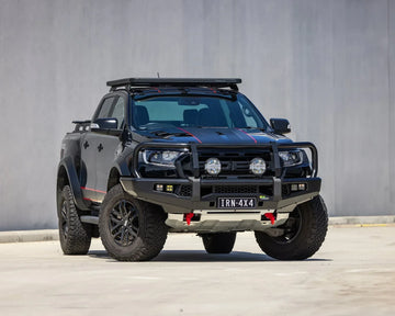IRONMAN 4x4 APEX bull bar fitted to a black Ford Ranger Raptor, front three-quarter view