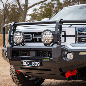 Close-up of the IRONMAN 4x4 Deluxe bull bar with driving lights on a BYD Shark 6