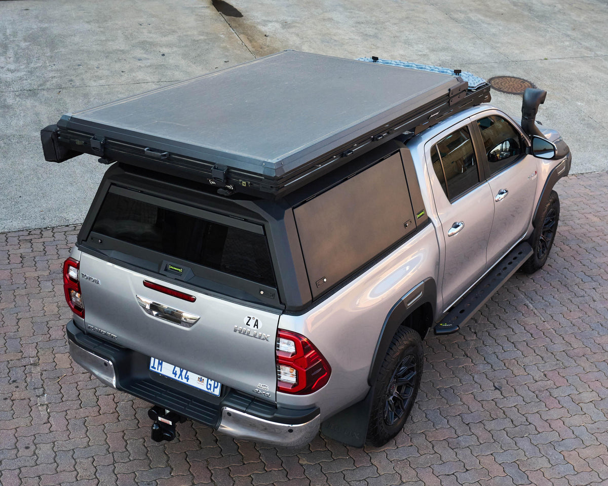 Aerial view of a RAID Hybrid canopy on a silver Toyota Hilux GD-6 with rooftop tent