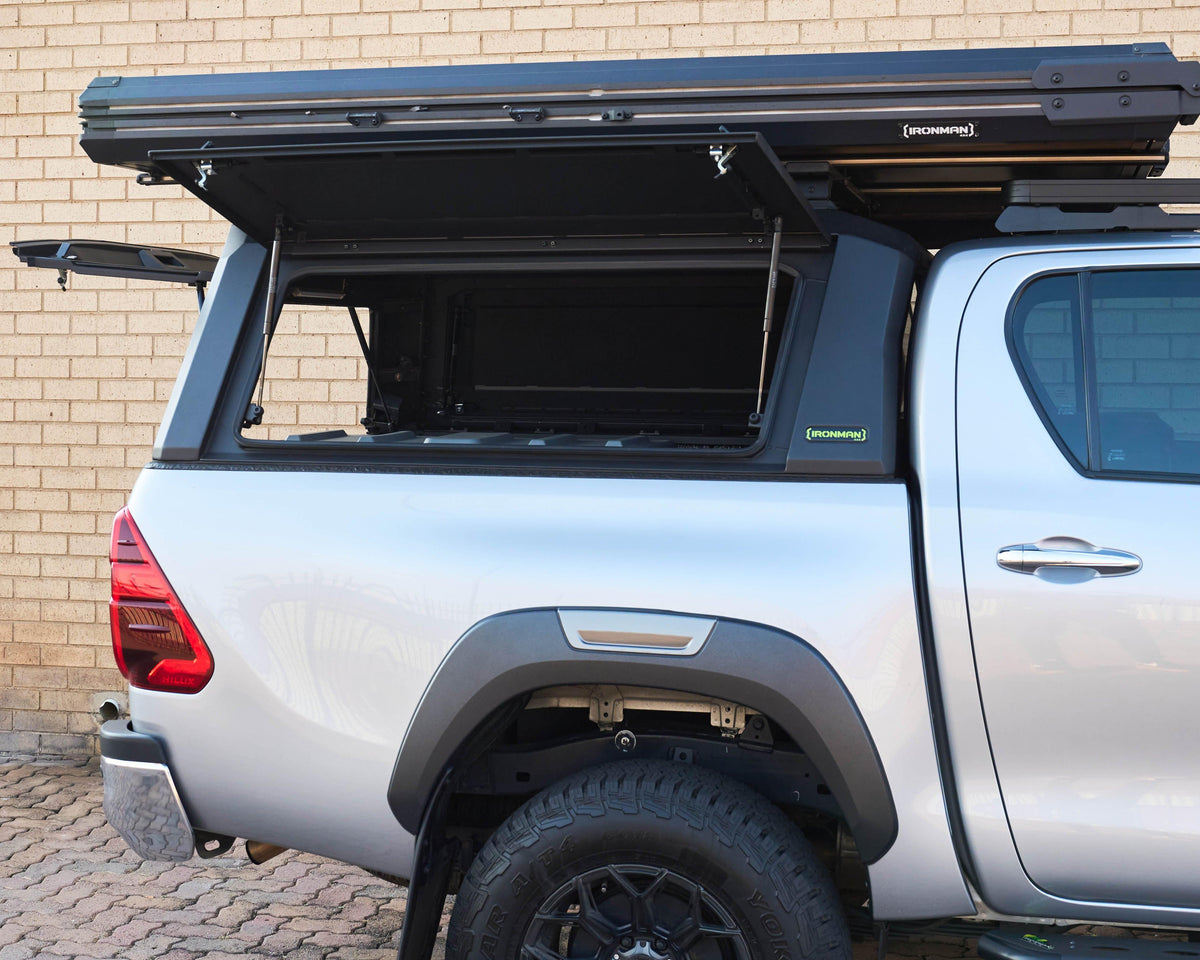 RAID Hybrid canopy on a silver Toyota Hilux GD-6 with side door lifted open