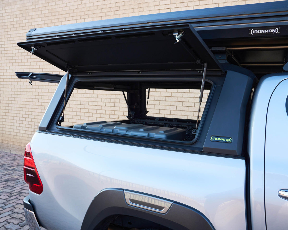 RAID Hybrid canopy on a silver Toyota Hilux GD-6 with side door open, showing the interior