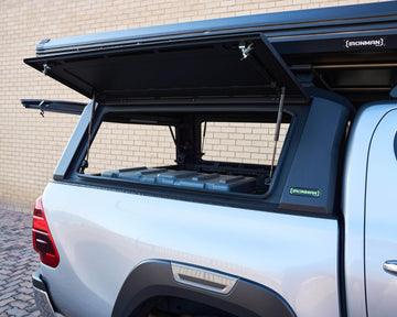 RAID Hybrid canopy on a silver Toyota Hilux GD-6 with side door open, showing the interior