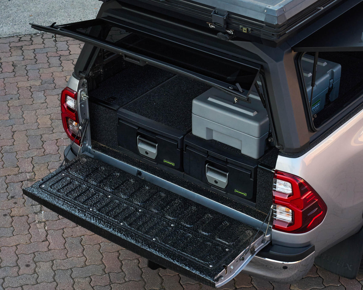 IRONMAN 4x4 mixed height drawers inside a RAID canopy on a Toyota Hilux, tailgate down