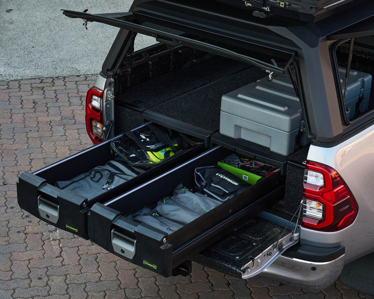 IRONMAN 4x4 roller drawers open in a bakkie canopy, showing organised tools and gear