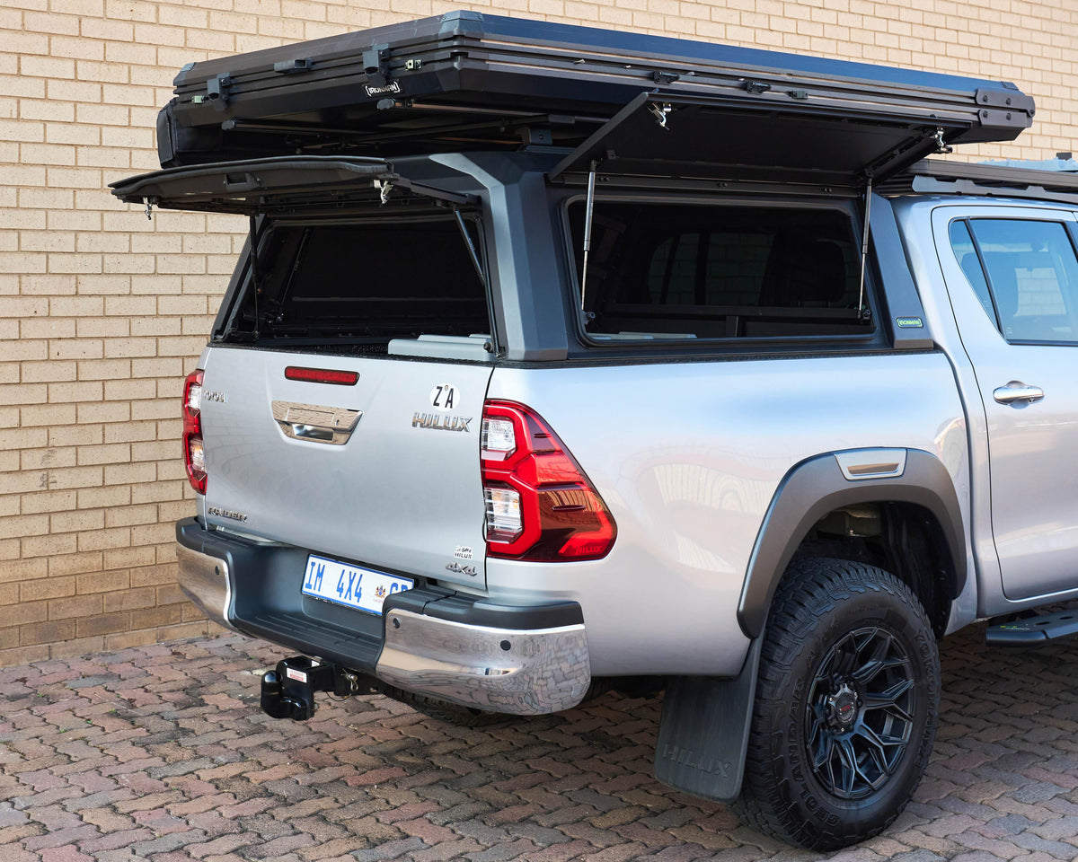 RAID Hybrid canopy with rooftop tent on a silver Toyota Hilux GD-6, doors open