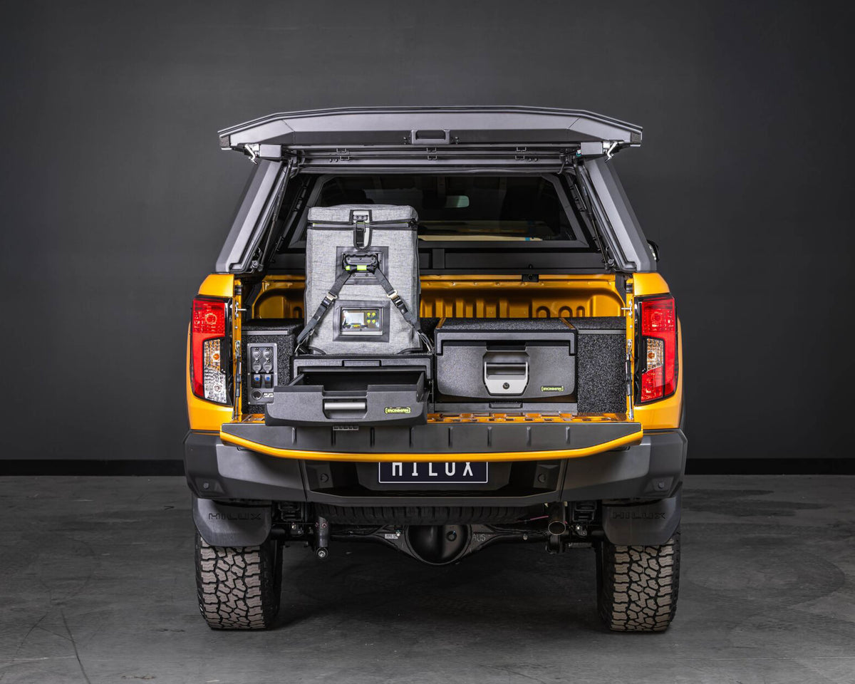 Orange Toyota Hilux with canopy and IRONMAN 4x4 drawer system, fridge on the slide