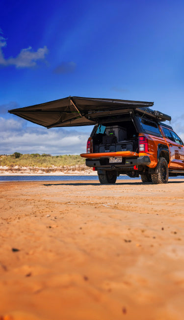 Orange Toyota Hilux with Awning, Drawer System on Beach Portrait