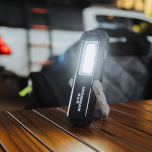 IRONMAN 4x4 rechargeable LED worklight standing on a table at camp