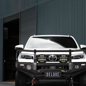 IRONMAN 4x4 Deluxe bull bar with driving lights fitted to a white Toyota Hilux GD-6