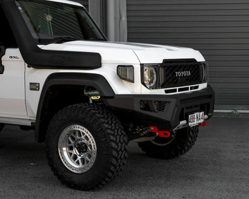 IRONMAN 4x4 RAID bull bar fitted to a white Toyota Land Cruiser 79 with snorkel, close-up