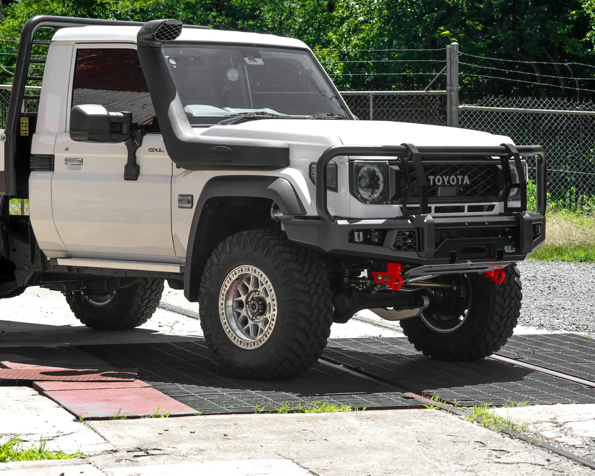 IRONMAN 4x4 APEX bull bar fitted to a white Toyota Land Cruiser 79 single cab with snorkel