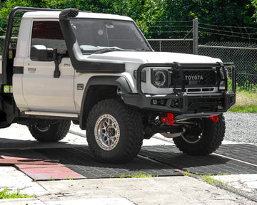 IRONMAN 4x4 APEX bull bar fitted to a white Toyota Land Cruiser 79 single cab with snorkel