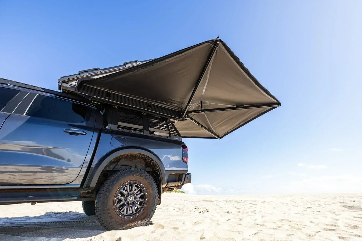 Deltawing 270 degree awning open on a grey 4x4, rear three-quarter view