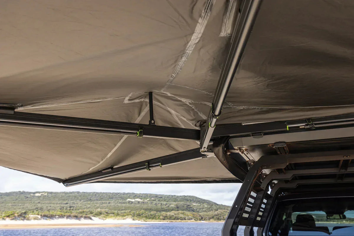 Underside of the Deltawing 270 degree awning with a lake in the background