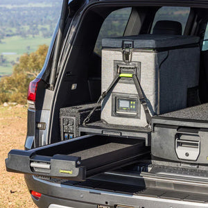 IRONMAN 4x4 roller drawer open with a fridge on the slide, fitted in an SUV parked outdoors