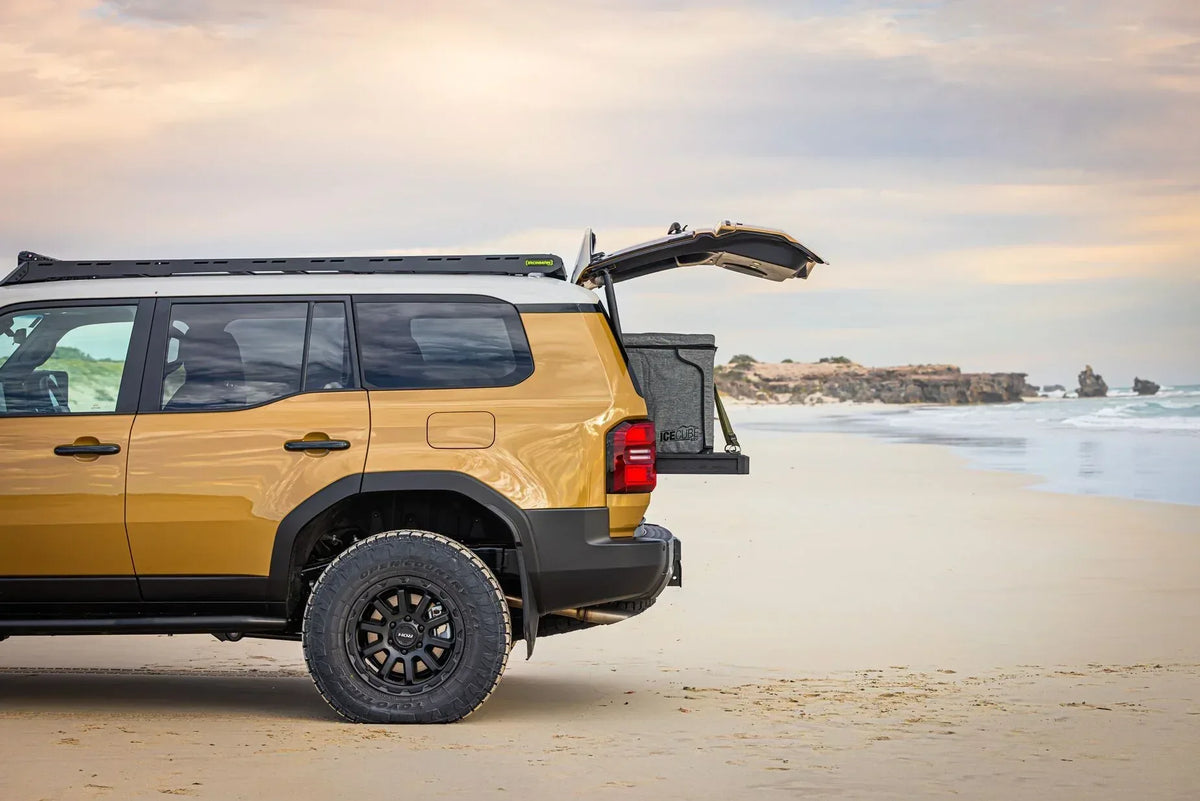 Side view of a Toyota Prado 250 on the beach with IRONMAN 4x4 drawers fitted in the back