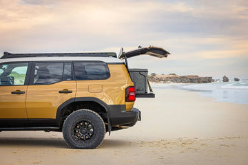 Side view of a Toyota Prado 250 on the beach with IRONMAN 4x4 drawers fitted in the back