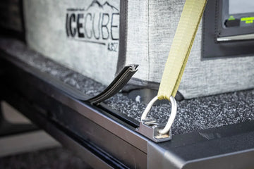 Close-up of an IRONMAN 4x4 drawer tie-down point securing a fridge with a strap