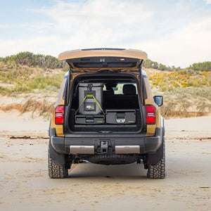 Rear view of a Toyota Prado 250 on the beach with IRONMAN 4x4 drawers and a fridge in the back