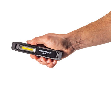 Hand holding the IRONMAN 4x4 rechargeable LED worklight combo