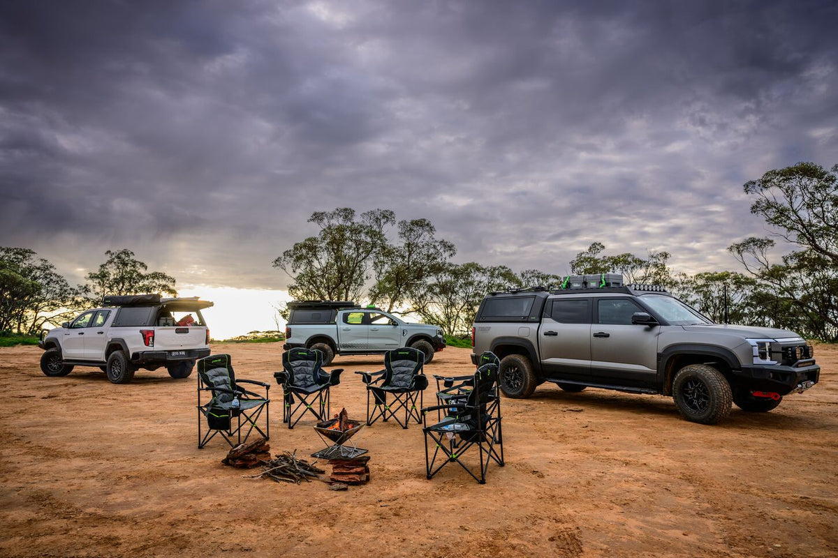 IRONMAN 4x4 King quad fold camp chairs around a fire pit at a bush camp with 4x4s