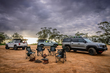 IRONMAN 4x4 King quad fold camp chairs around a fire pit at a bush camp with 4x4s