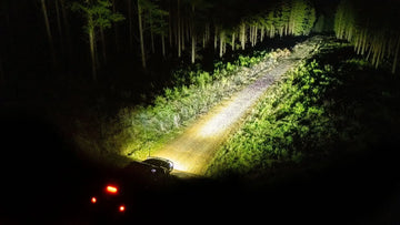 Beam pattern of IRONMAN 4x4 Scope NEO 7 inch driving lights on a forest track at night