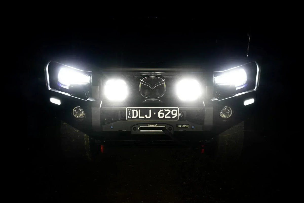 Vehicle with IRONMAN 4x4 Scope NEO 7 inch driving lights switched on at night