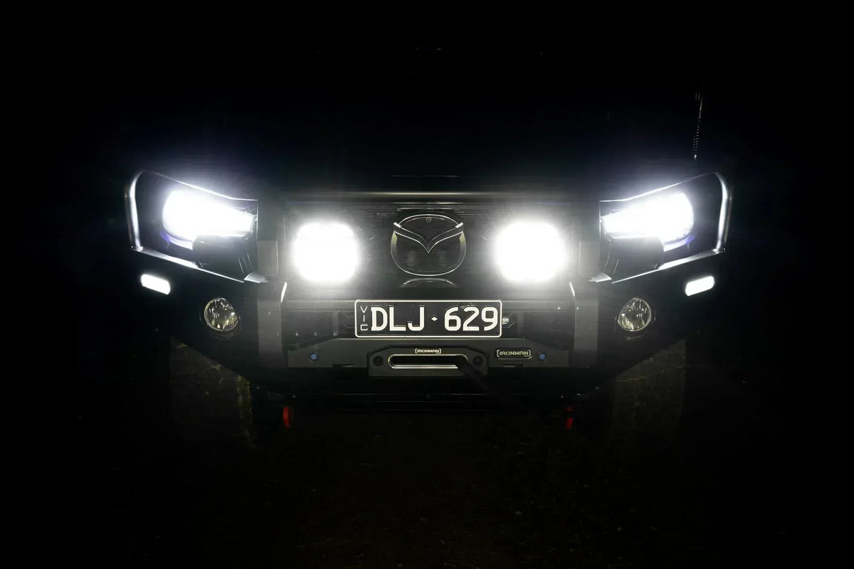 Vehicle with IRONMAN 4x4 Scope NEO 7 inch driving lights switched on at night