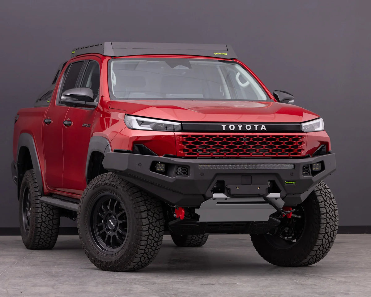 IRONMAN 4x4 RAID MKII bull bar fitted to a red Toyota Hilux Travo, front view