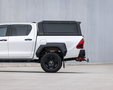 RAID Full Glass canopy on a white Toyota Hilux GD-6, side view