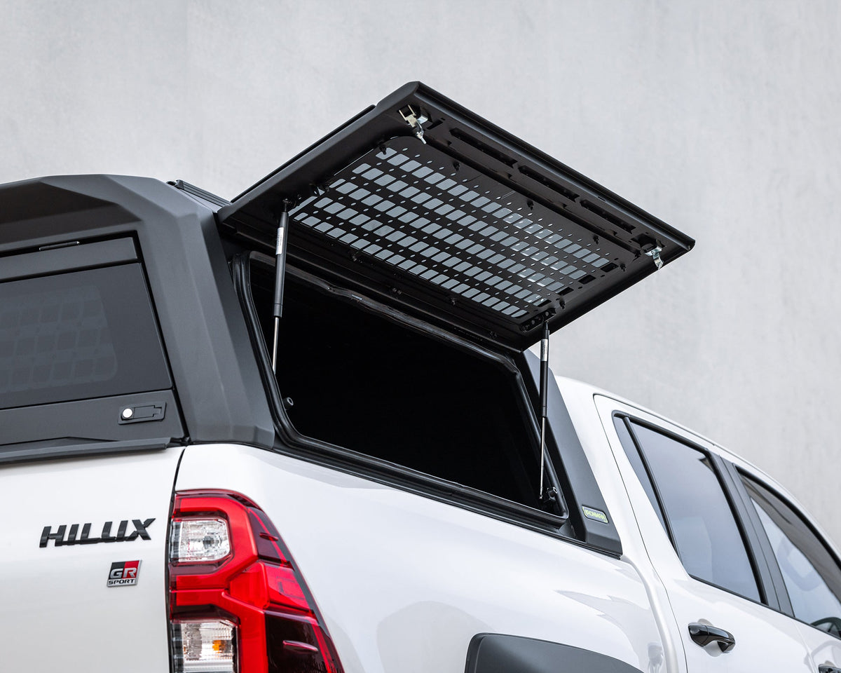 RAID Full Glass canopy side window lifted open on a white Toyota Hilux GD-6
