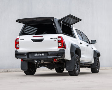 RAID Full Glass canopy with side windows open on a white Toyota Hilux GD-6, rear view