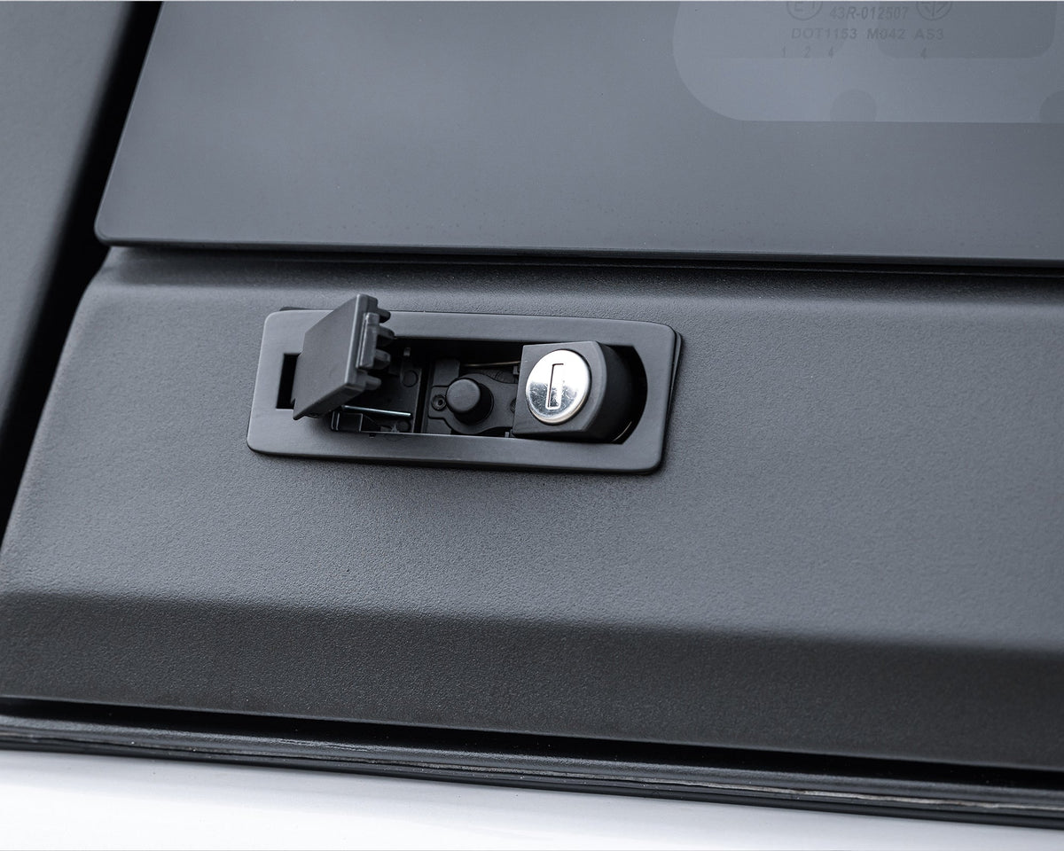 Close-up of the push-button lock on a RAID Full Glass canopy window