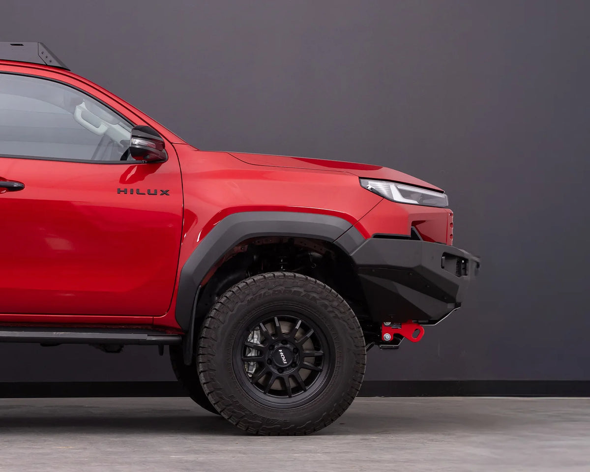 Side view of the IRONMAN 4x4 RAID MKII bull bar fitted to a red Toyota Hilux Travo