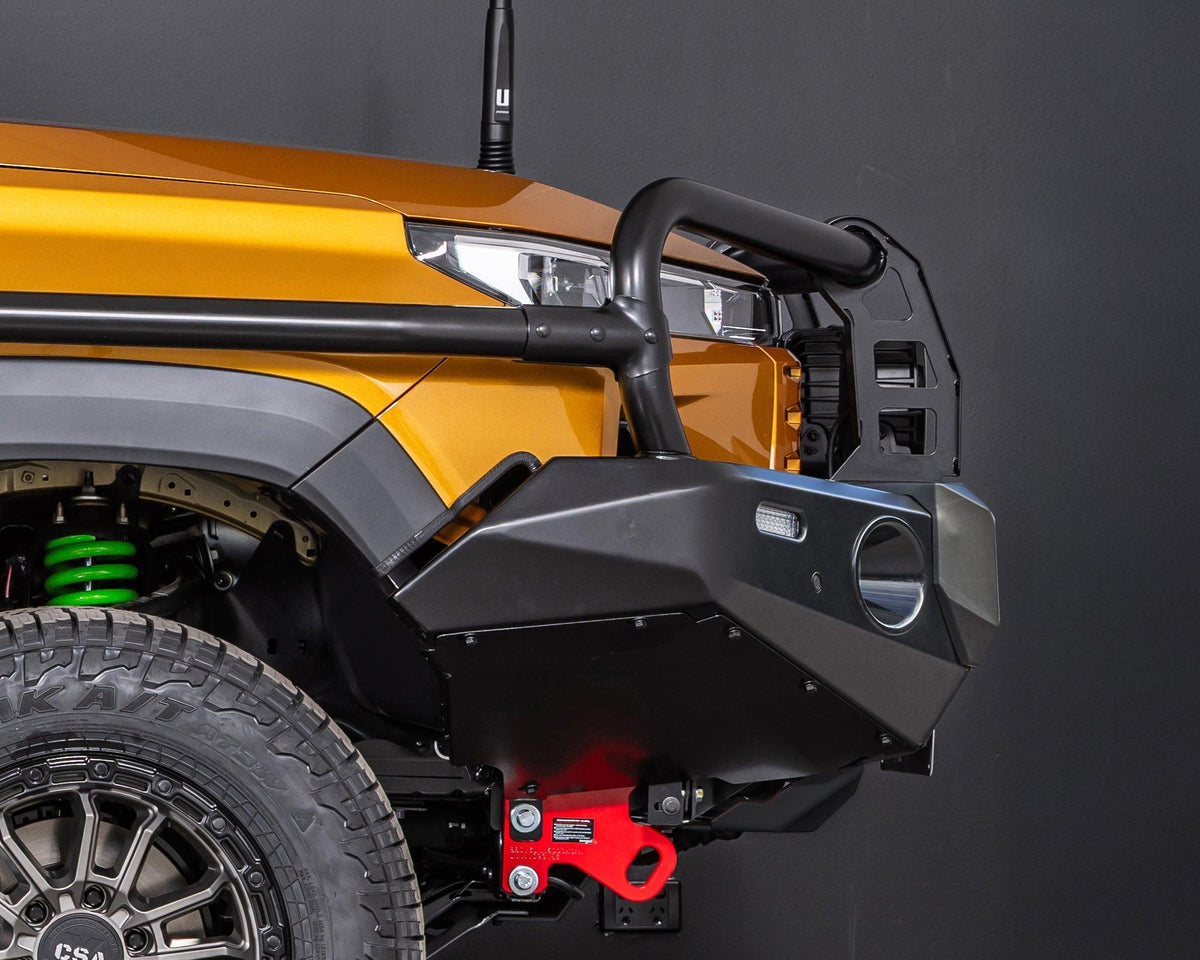 Side view of the IRONMAN 4x4 Deluxe bull bar fitted to an orange Toyota Hilux Travo